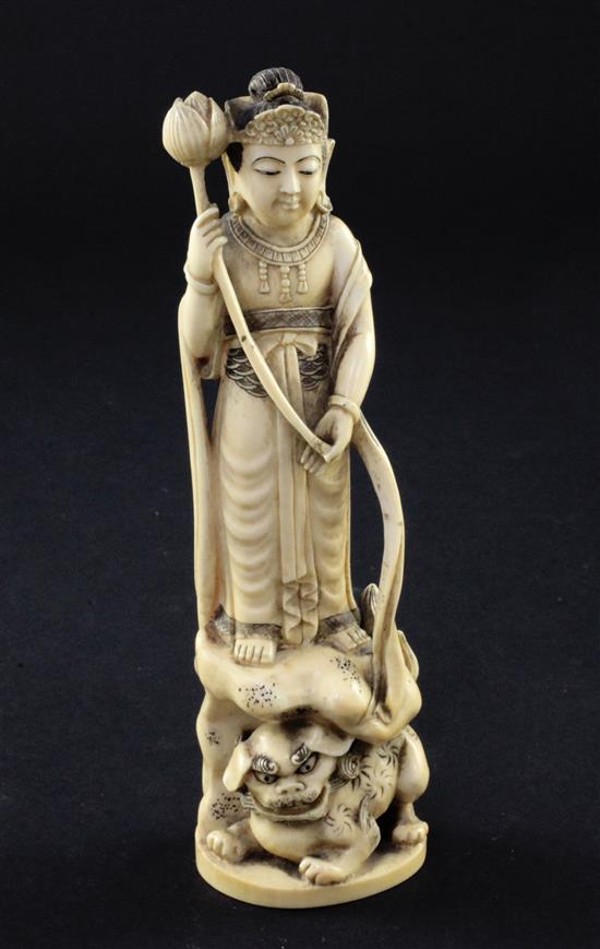 A Japanese ivory group of an immortal and a shi-shi, early 20th century, 18cm